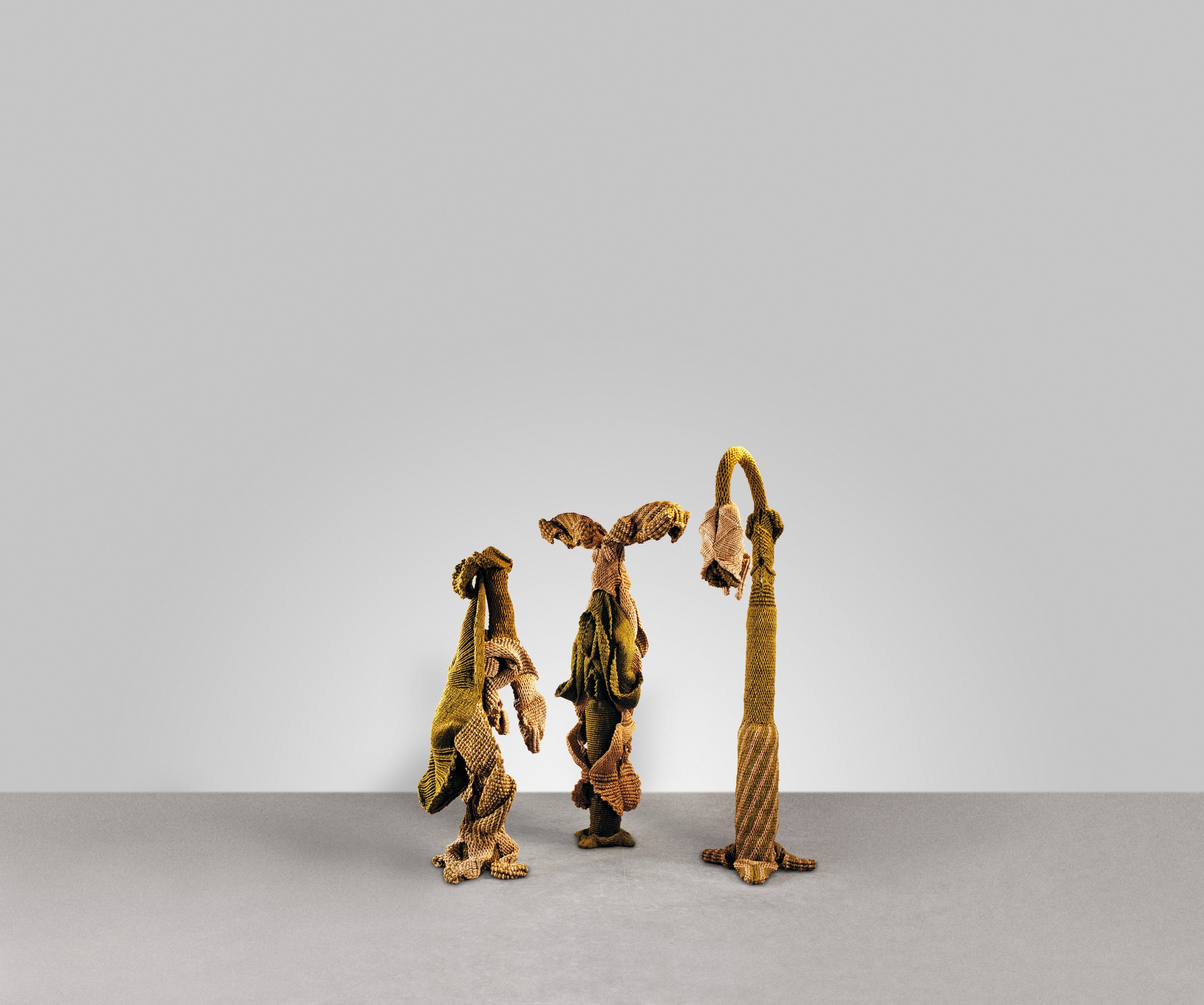 Mrinalini Mukherjee, (Indian, 1949–2015) Vriksh Nata (Arboreal Enactment), (3 pieces), 1991–92 Natural and dyed hemp Left: 87 1/2 × 53 × 19 1/2 in (222 × 135 × 50 cm) Centre: 93 1/2 × 46 × 27 in (237 × 117 × 69 cm) Right: 66 × 35 1/2 × 27 in (168 × 90 × 68 cm) Collection Kiran Nadar Museum of Art, New Delhi © Mrinalini Mukherjee Photo © Avinash Pasricha